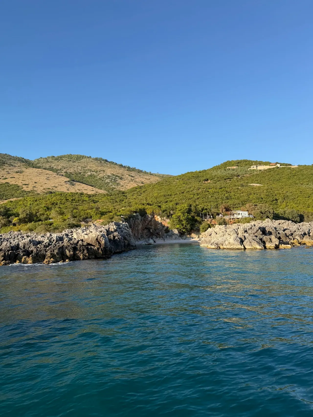 Boat cruising past dramatic cliffs